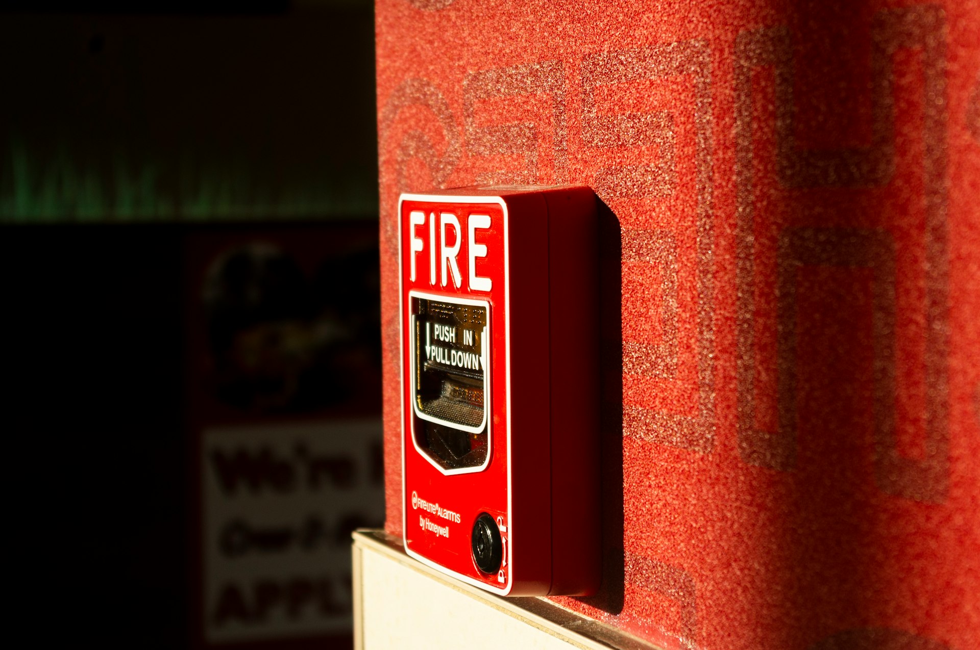 a red fire extinguisher on a red wall